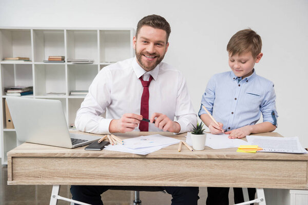 Businessman with son at office