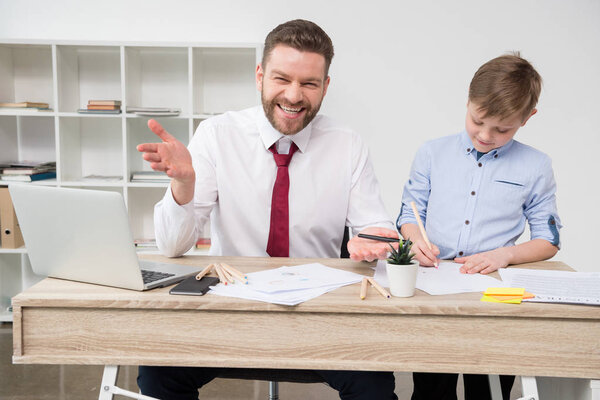 Businessman with son at office