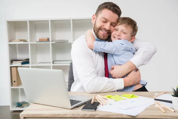 Businessman hugging with son