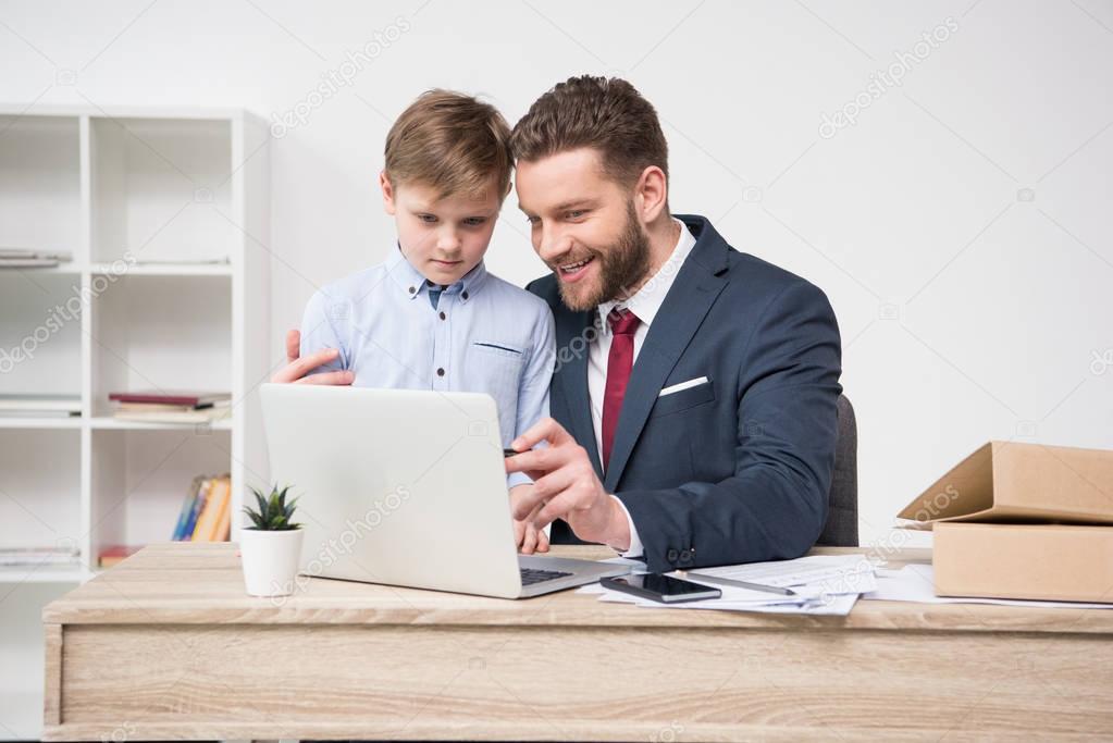 Businessman with his son in office