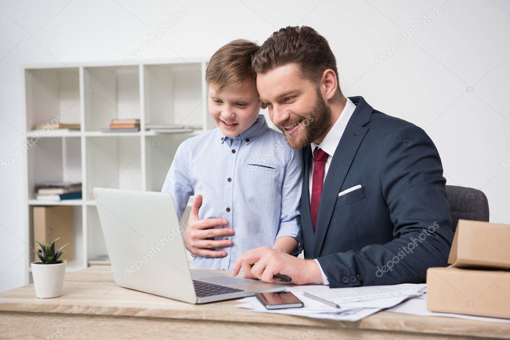 Businessman with his son in office