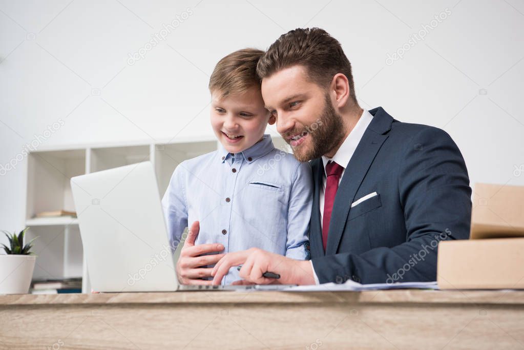 Businessman with his son in office