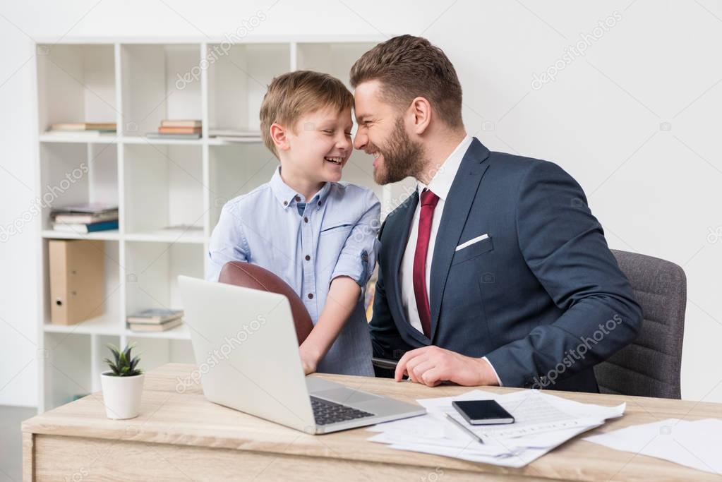 Businessman with his son in office