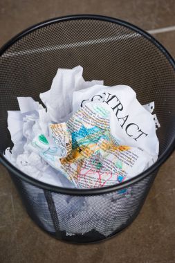 wrinkled business papers in trash bucket  clipart