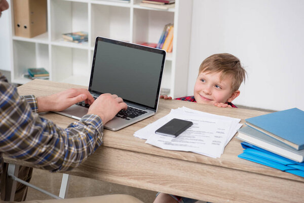 Businessman with son at home office