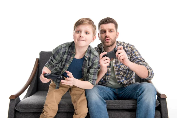 Father and son playing with joysticks — Stock Photo, Image