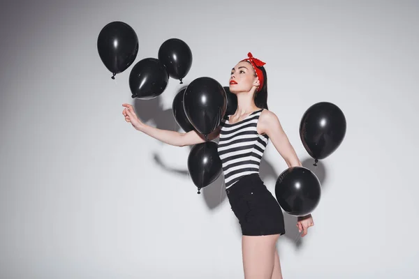 Stylische Frau mit schwarzen Luftballons — Stockfoto