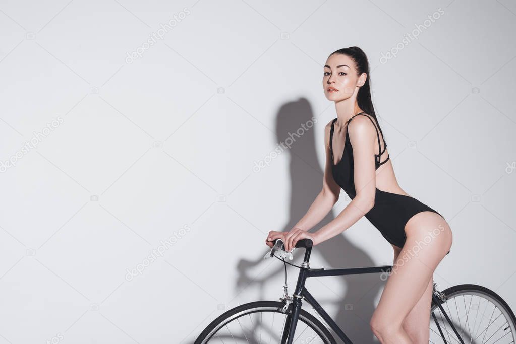 Woman in bodysuit on bicycle