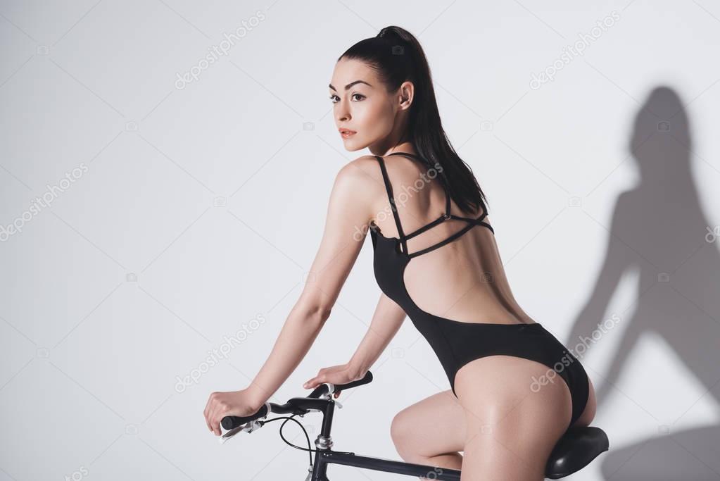 Woman in bodysuit on bicycle