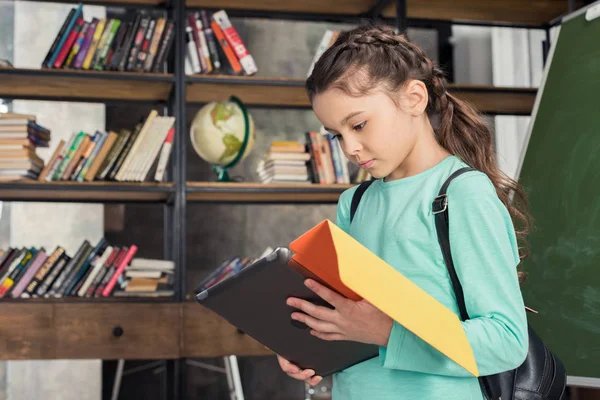 Schoolgirl with digital tablet — Stock Photo