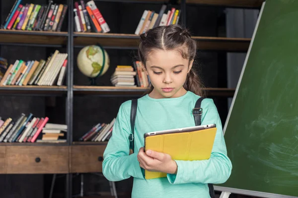 Schoolgirl with digital tablet — Stock Photo