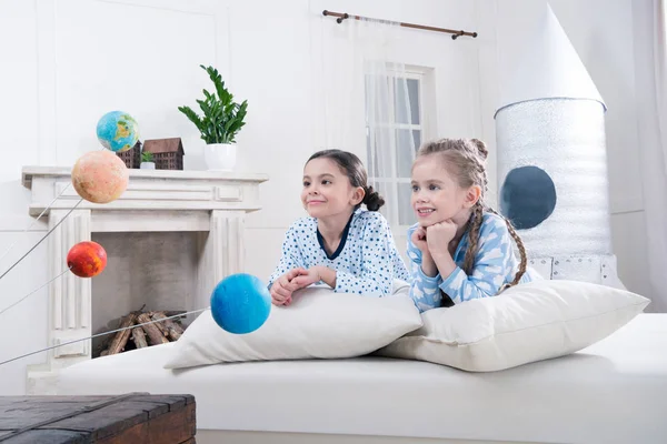 Girls looking at planets models — Stock Photo