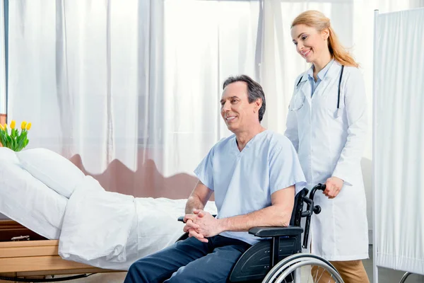 Elderly man sitting in wheelchair — Stock Photo