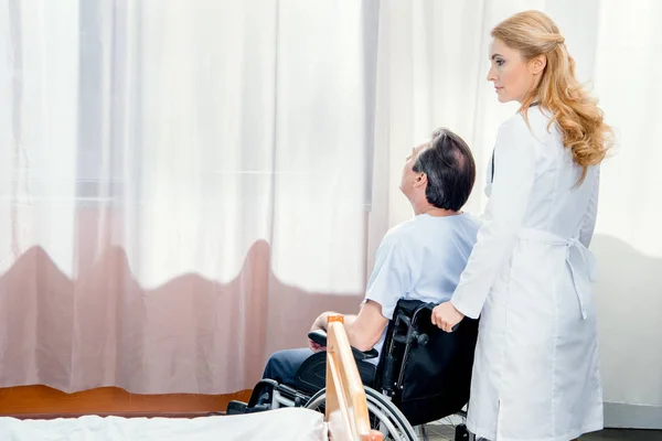 Elderly man sitting in wheelchair — Stock Photo