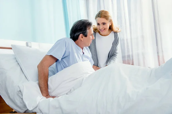 Woman helping husband stand up — Stock Photo