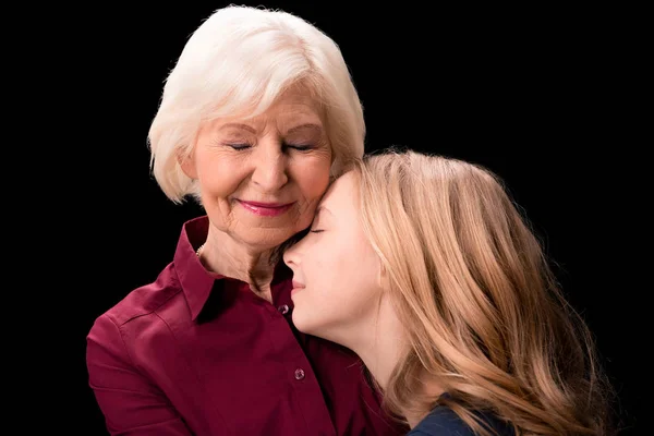 Grandchild and grandmother hugging — Stock Photo