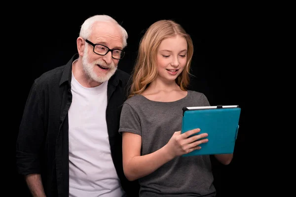 Grandfather and granddaughter with digital tablet — Stock Photo