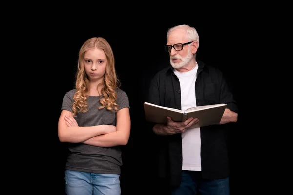 Grandfather and granddaughter with book — Stock Photo