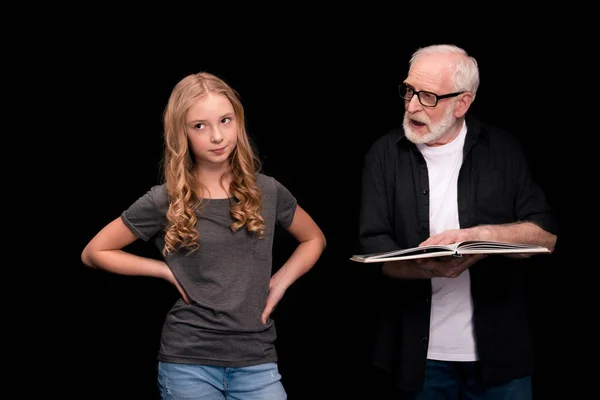 Grandfather and granddaughter with book — Stock Photo