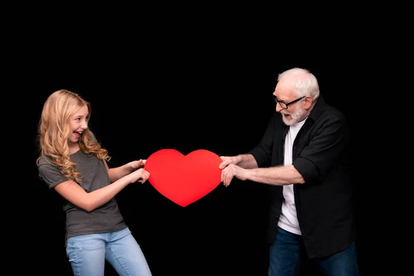 Grandfather and granddaughter with heart symbol — Stock Photo