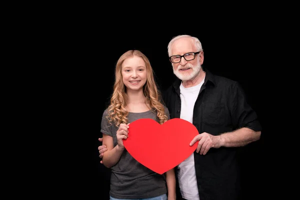Grandfather and granddaughter with heart symbol — Stock Photo
