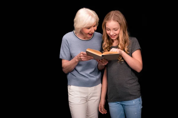 Grandmother and granddaughter with book — Stock Photo