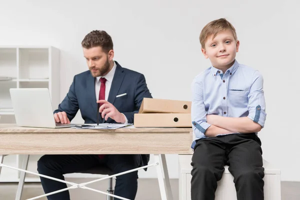 Niño travieso con su padre hombre de negocios — Stock Photo