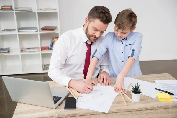 Businessman with son in office — Stock Photo