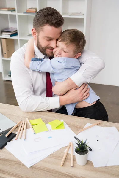 Businessman hugging with son — Stock Photo