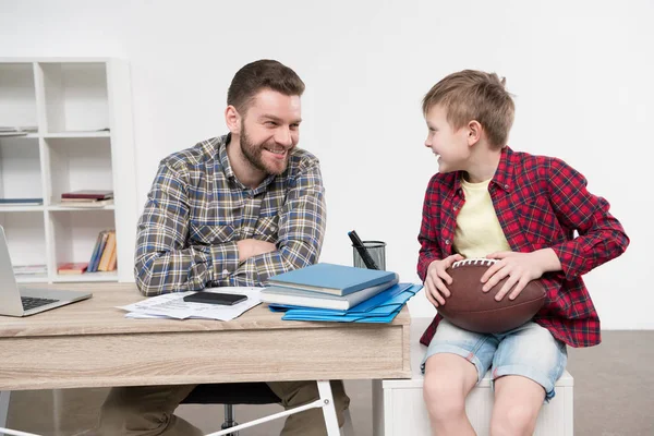 Businessman with son at home office — Stock Photo