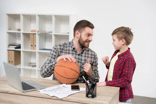 Businessman with son at home office — Stock Photo