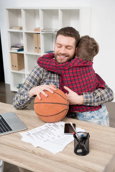 Businessman with son at home office — Stock Photo