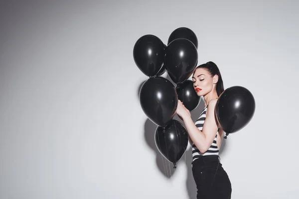 Mulher elegante com balões pretos — Fotografia de Stock