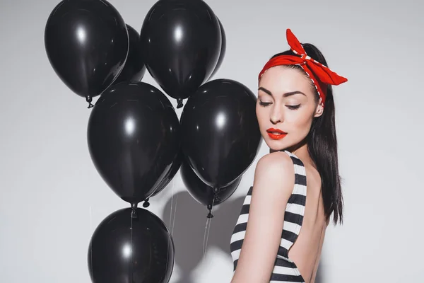 Stylish woman with black balloons — Stock Photo