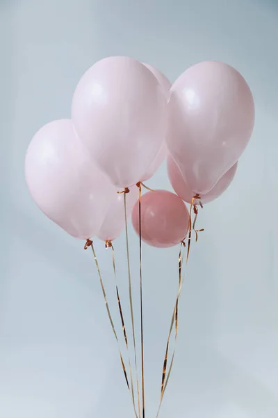 Pink air balloons with golden ribbons — Stock Photo, Image