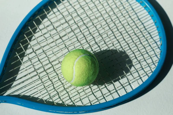 Tennis racket and ball on floor — Stock Photo, Image