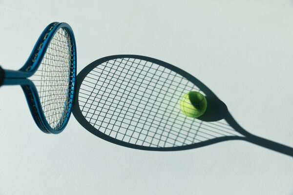 tennis racket and ball on floor 
