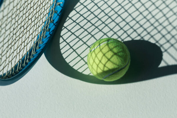 tennis racket and ball on floor 