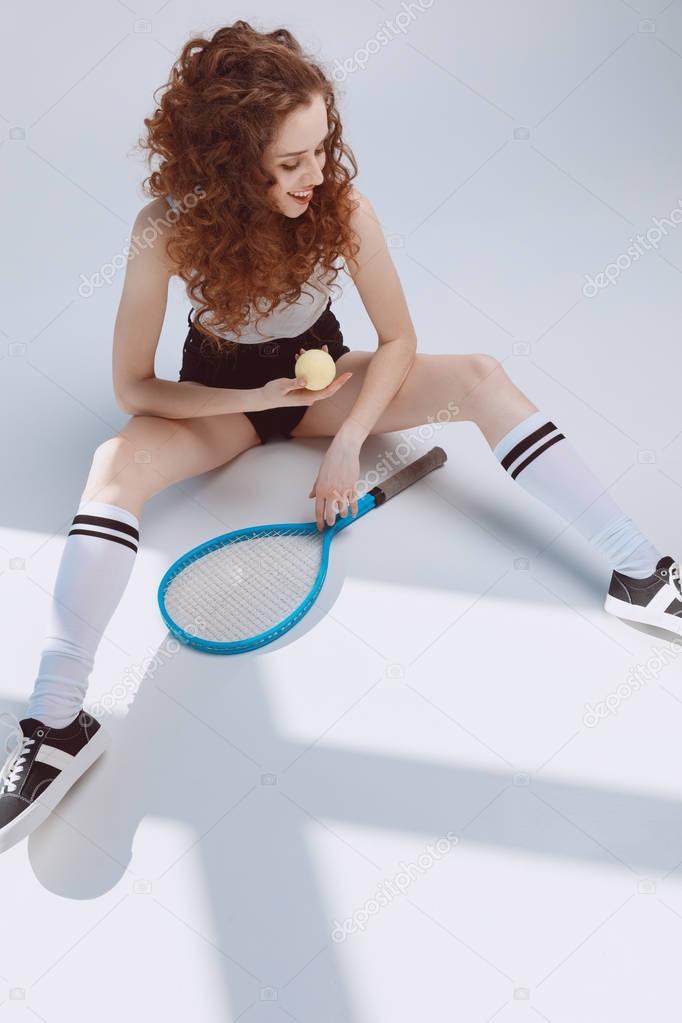 Young woman with racket 