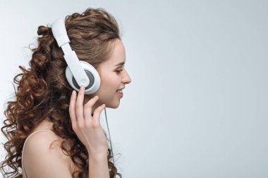 woman listening music in headphones clipart