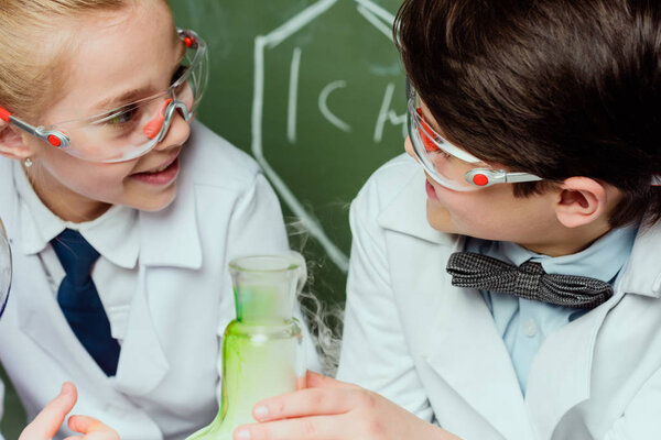 kids in white coats in laboratory
