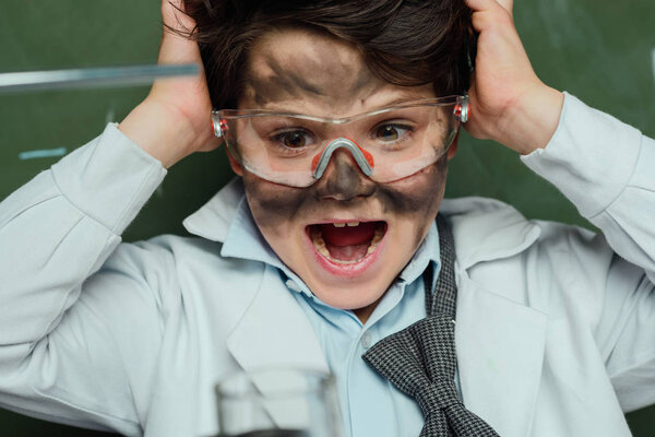 shocked boy in lab coat