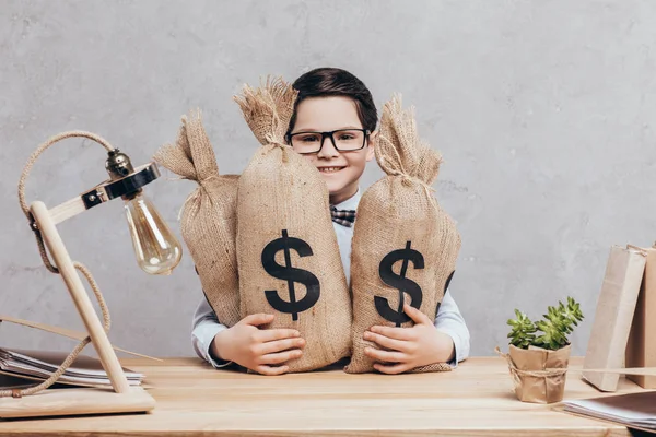 Little boy with moneybags — Stock Photo, Image