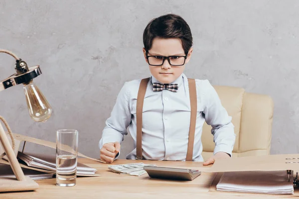 Angry little boy at workplace — Stock Photo, Image