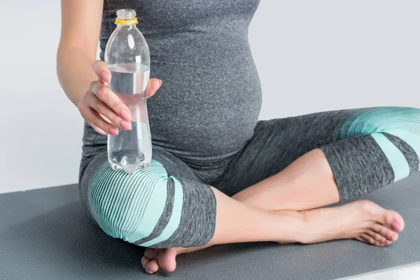 Pregnant woman with bottle of water — Stock Photo, Image