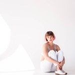 Young woman sitting on floor