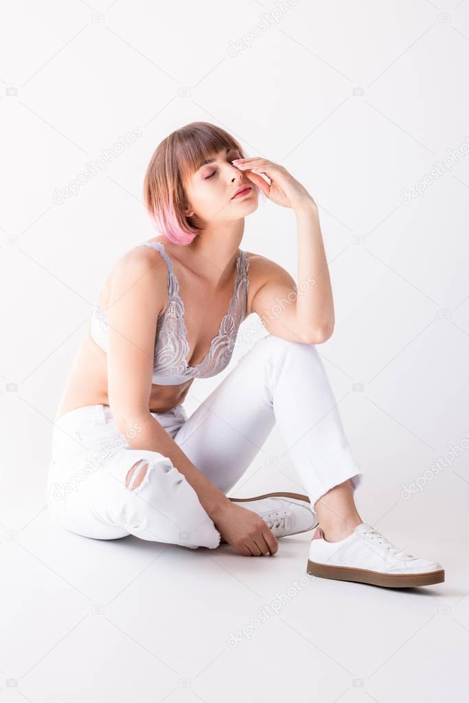 Tired woman sitting on floor