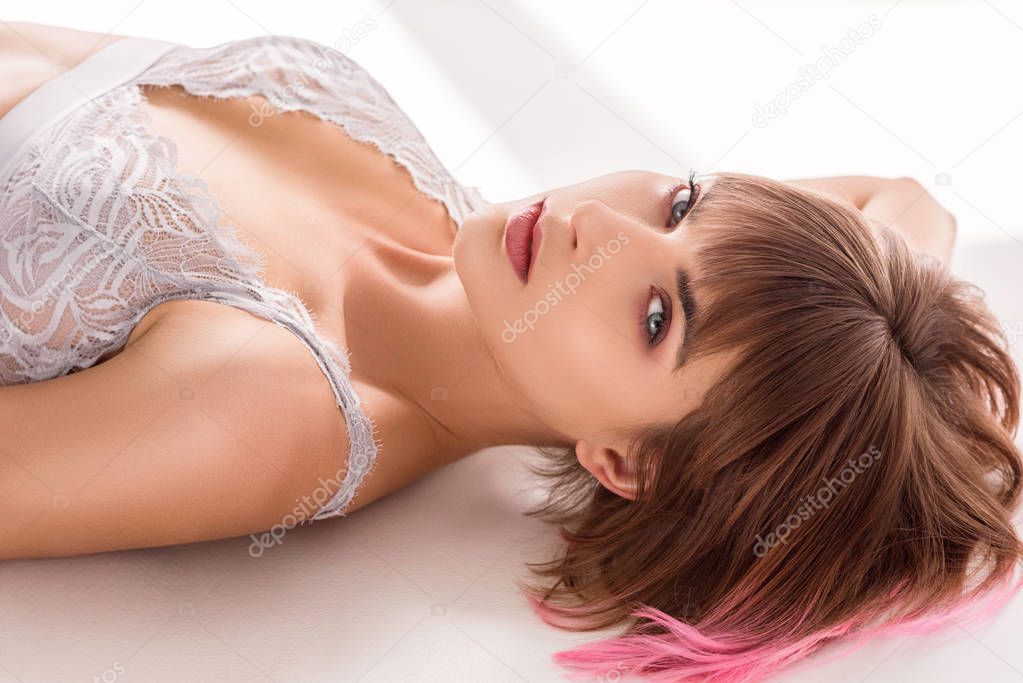 woman in lace bralette lying on floor