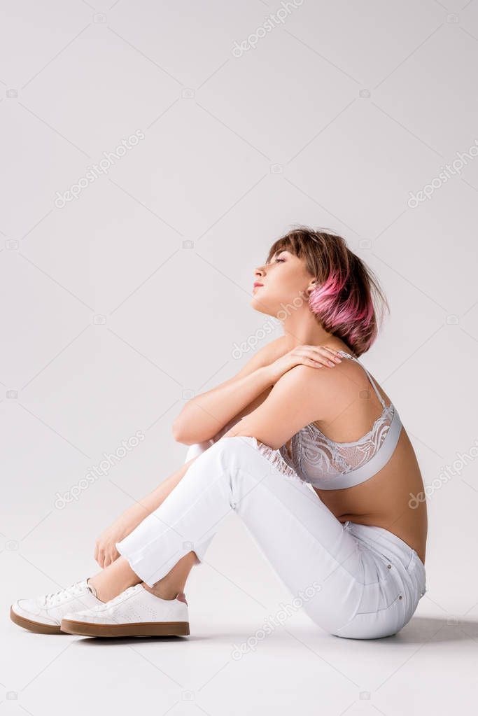 Young woman sitting on floor