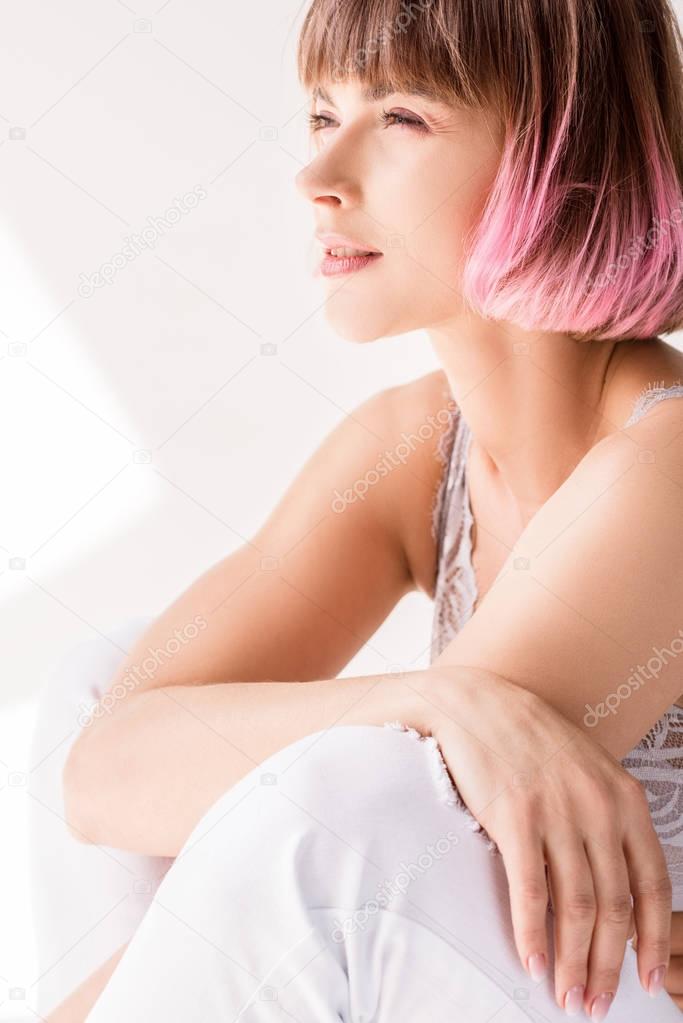 woman sitting on floor and squinting eyes